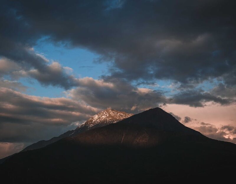 Mountain Landscapes - A stunning view of a mountain peak silhouetted a #12357274