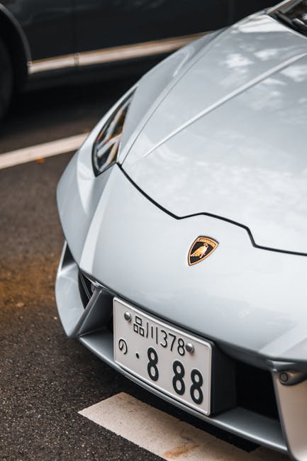 Luxury Cars - Detailed view of a silver Lamborghini's front bu #23124136