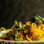 Food Aesthetics - Close-up of a vibrant Indian noodle dish garnish #4635600